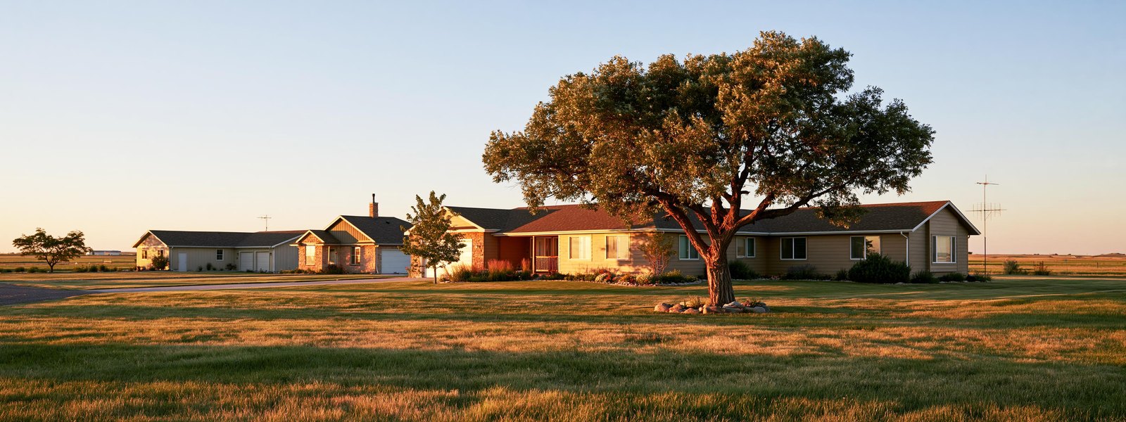 Residential street in Fountain, Colorado, with single-story houses and open sky